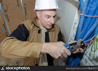 electrician cutting cables in a construction site