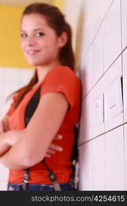 Electrician female leaning against tiled wall