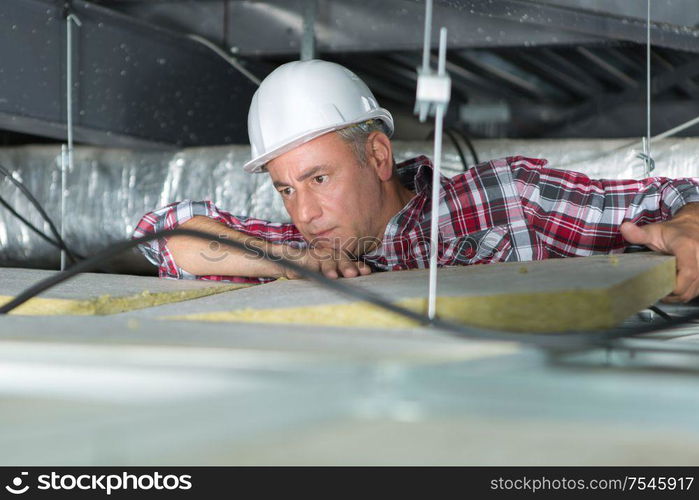 electrician fixing neon on the ceiling