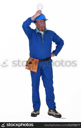 electrician holding a bulb over his head