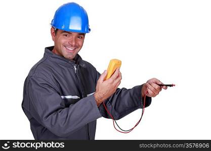 electrician holding a measurement tool and smiling
