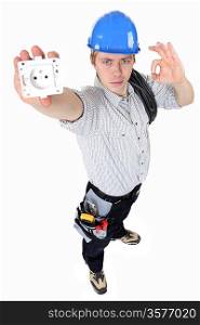 electrician holding an electrical socket and making an okay sign