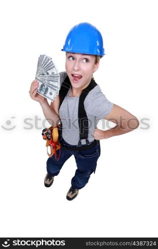 Electrician holding bunch of dollars