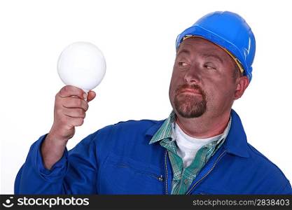 Electrician holding light bulb