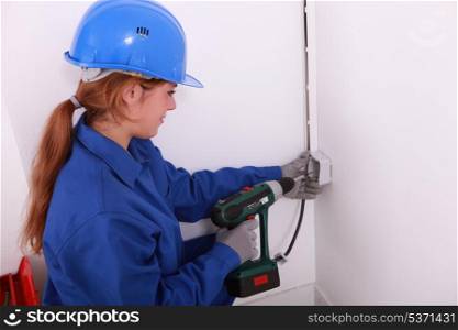 Electrician installing a wall socket
