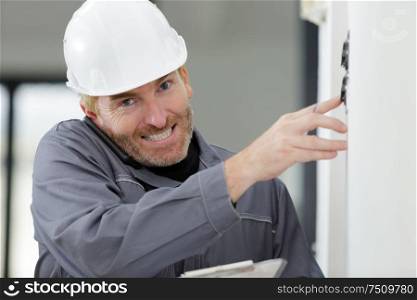 electrician installing socket in new house
