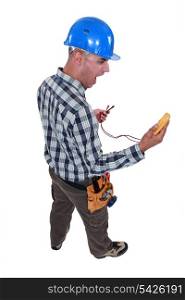 electrician looking at his measurement tool and screaming of surprise