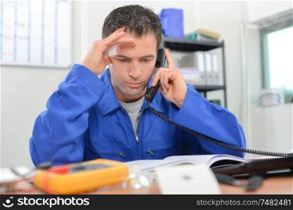 Electrician on the phone in his office