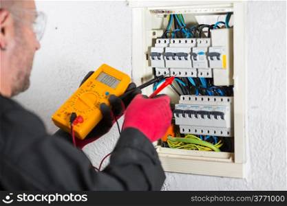 Electrician performing checks on a light box