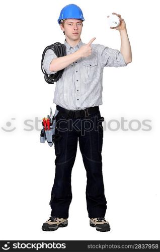 electrician pointing at the object he is holding