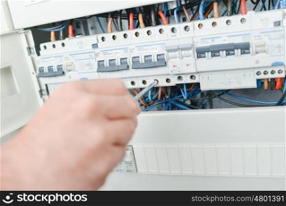 Electrician repairing a fuse