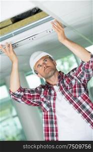electrician repairing ceiling light