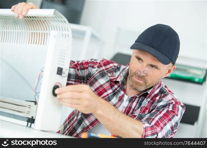 Electrician repairing heater