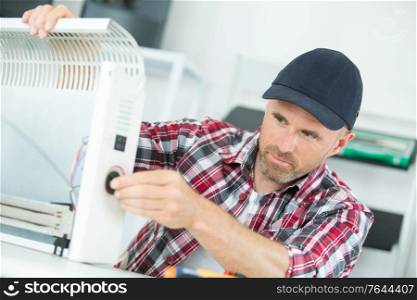 Electrician repairing heater