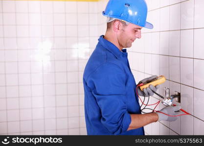 Electrician testing the current with a multimeter