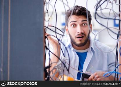 Electrician trying to untangle wires in repair concept. The electrician trying to untangle wires in repair concept