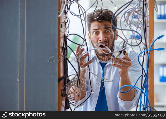 Electrician trying to untangle wires in repair concept. The electrician trying to untangle wires in repair concept