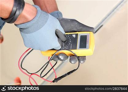 Electrician using voltmeter