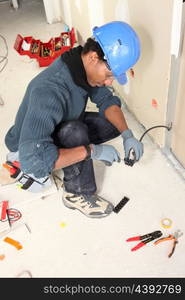 Electrician wiring a building