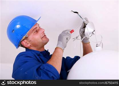 Electrician wiring a ceiling light