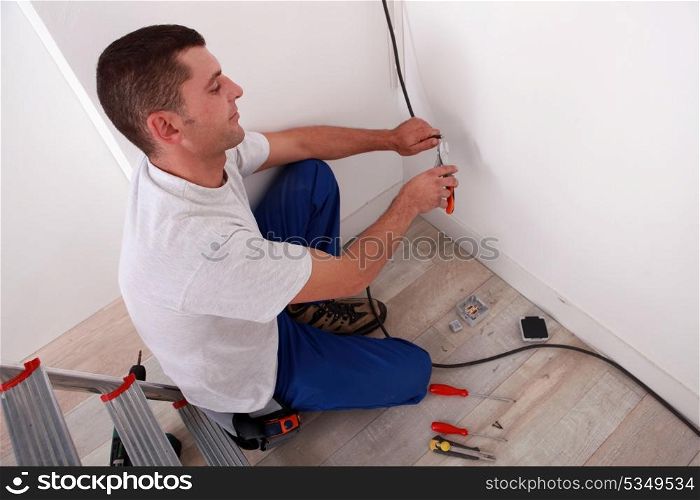 Electrician wiring a home