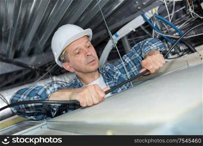 electrician wiring inside ceiling