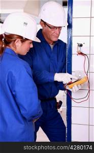 Electrician with female apprentice