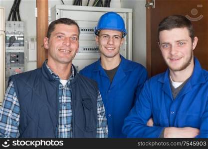 electrician workers next to fuse board