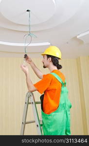 Electrician working on cabling lighting