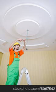 Electrician working on cabling lighting