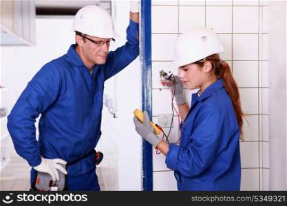electricians taking measurements