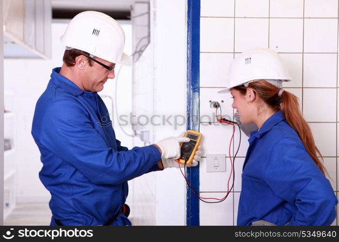 Electricians with voltmeter