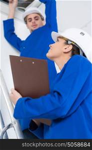 electricians working in buildings ceiling