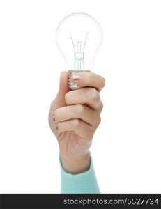 electricity and energy concept - close up of woman hand holding light bulb