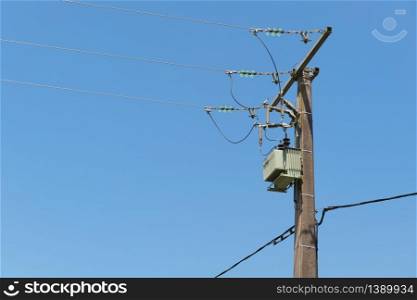 Electricity pole and threads against blue sky
