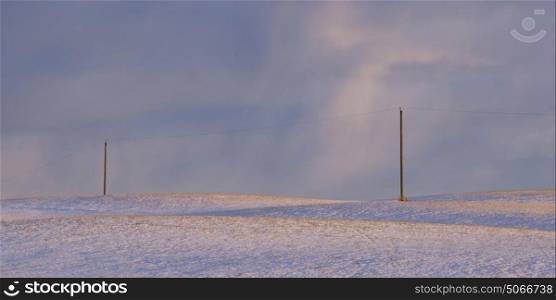 Electricity poles on snow covered landscape, Cowboy Trail, Alberta Highway 22, Alberta, Canada