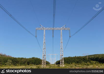 Electricity pylon power pole high voltage against blue sky