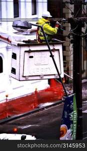 Electricity worker mending power lines