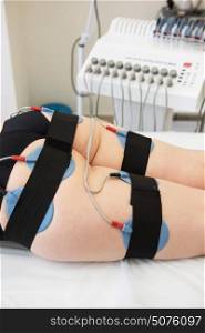 electro stimulation therapy. Body treatment: middle aged woman getting getting electro stimulation therapy to her buttocks