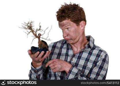 Electrocuted man holding a plant
