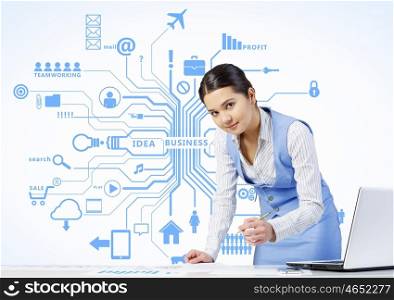 Electronic business and networking. Businesswoman at table working on laptop presenting social connection concept