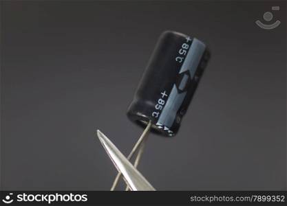 Electronic capacitor in black background