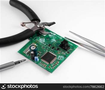 electronic circuit broken and repair tools, pliers, wire cutters and screwdrivers