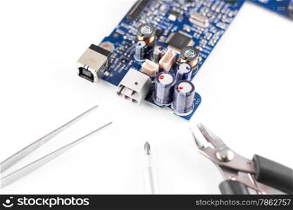 electronic circuit broken and repair tools, pliers, wire cutters and screwdrivers