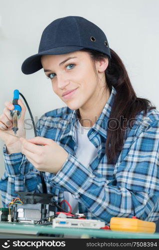 electronic lab working place with soldering iron and circuit board