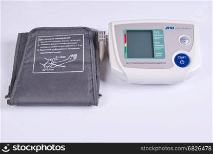 Electronic medical tonometer on a white background.. Medical equipment - automatic blood pressure monitor on a white background.