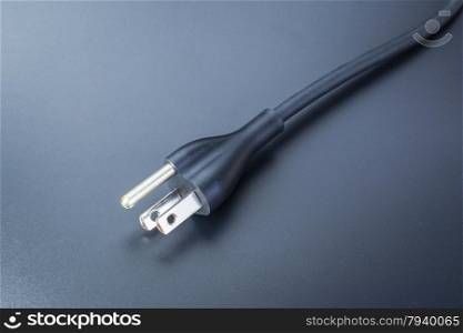 electronic power plug for laptop computer on black background,close up