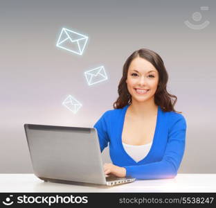 electronics and gadget concept - smiling woman in blue clothes with laptop computer