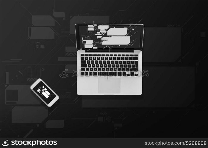 electronics and technology concept - laptop computer and smartphone top view. laptop computer and smartphone top view