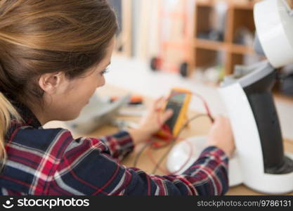 electronics repair tech fixes curcuit board